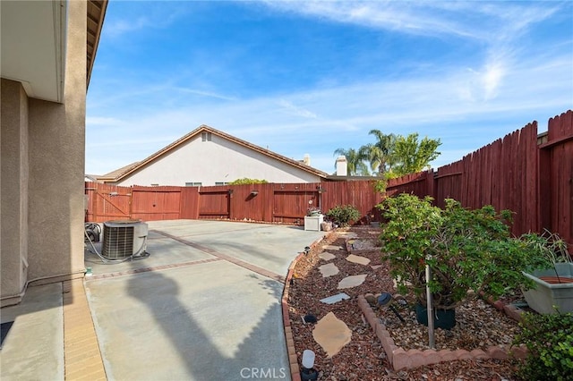 view of yard featuring central AC unit and a patio