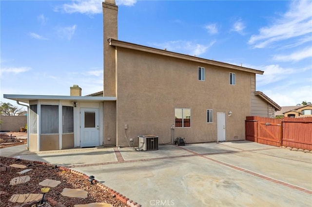 rear view of house with a patio and central air condition unit