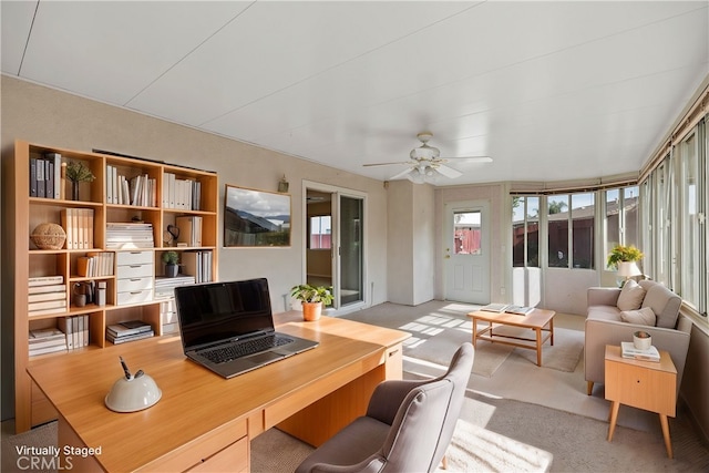 carpeted office space featuring ceiling fan