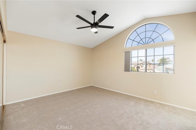 carpeted empty room with lofted ceiling and ceiling fan