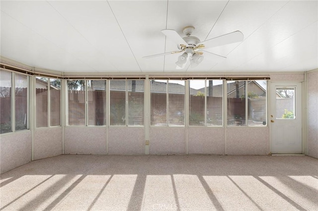 unfurnished sunroom with ceiling fan