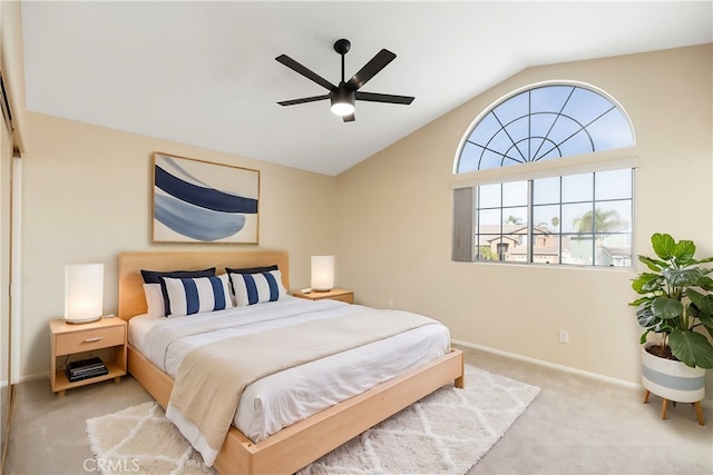 carpeted bedroom with ceiling fan and vaulted ceiling