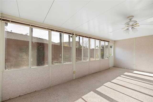 unfurnished sunroom with ceiling fan