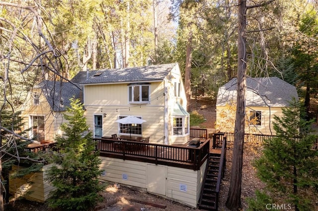 rear view of property featuring a wooden deck