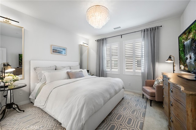 carpeted bedroom featuring a chandelier