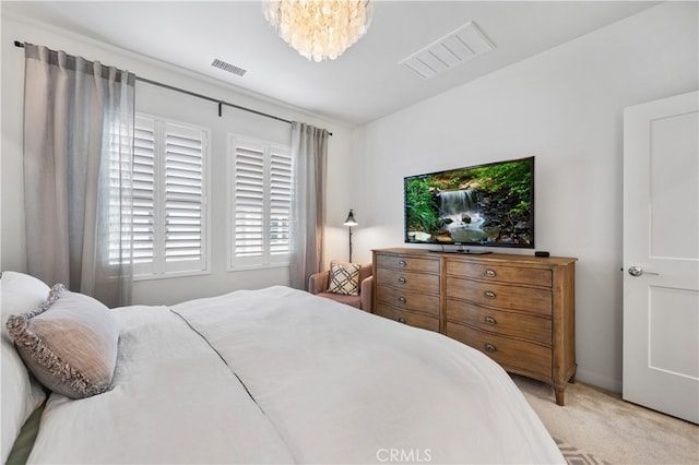 carpeted bedroom with a notable chandelier