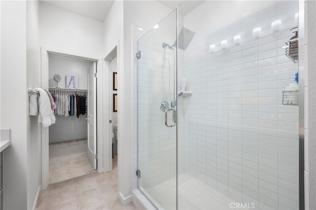 bathroom featuring tile patterned flooring, vanity, and a shower with shower door