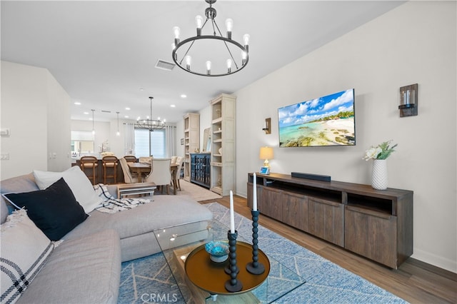 living room with hardwood / wood-style flooring and an inviting chandelier