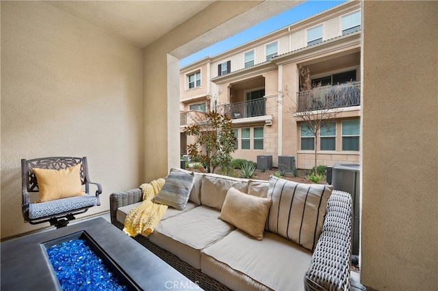 balcony with outdoor lounge area and central AC unit