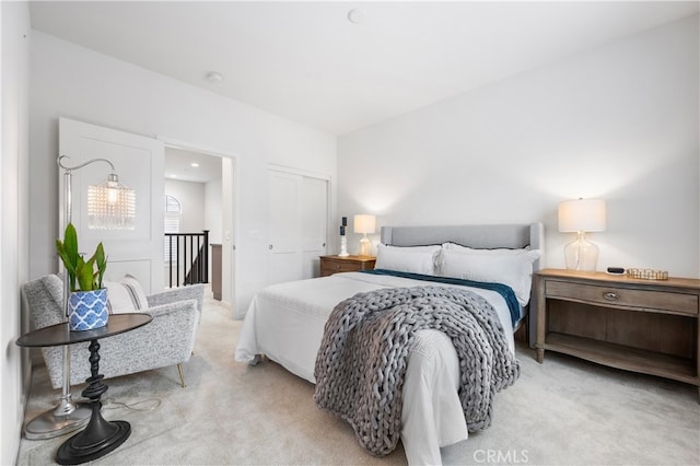 bedroom featuring light carpet and a closet