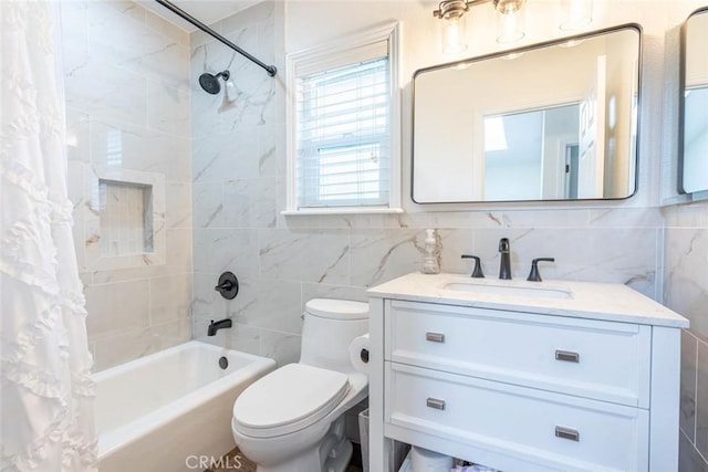 full bathroom featuring shower / bath combo, tile walls, vanity, and toilet