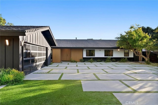 view of front of property with a garage and a front yard