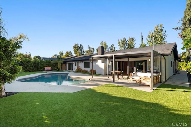 back of house featuring an outdoor living space, a yard, and a patio area