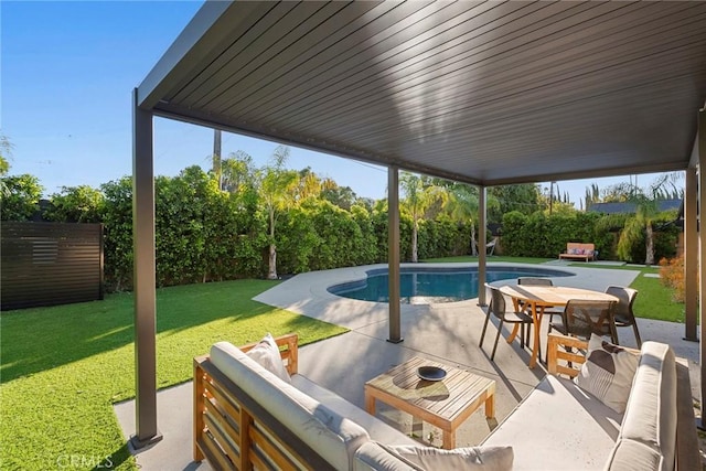 view of swimming pool with outdoor lounge area, a lawn, and a patio area