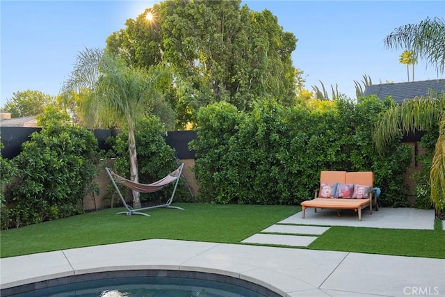 view of swimming pool with a yard and a patio