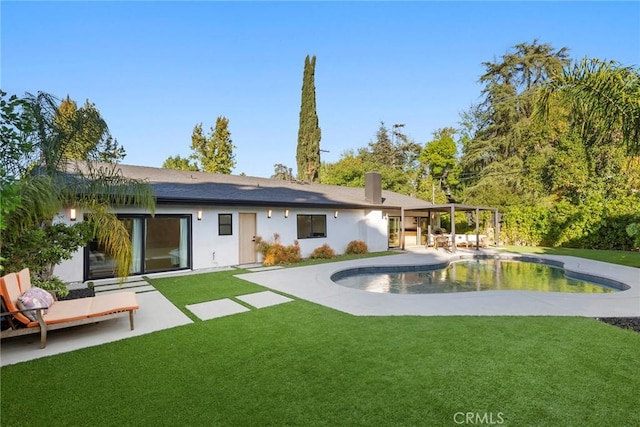 back of house with a patio and a lawn