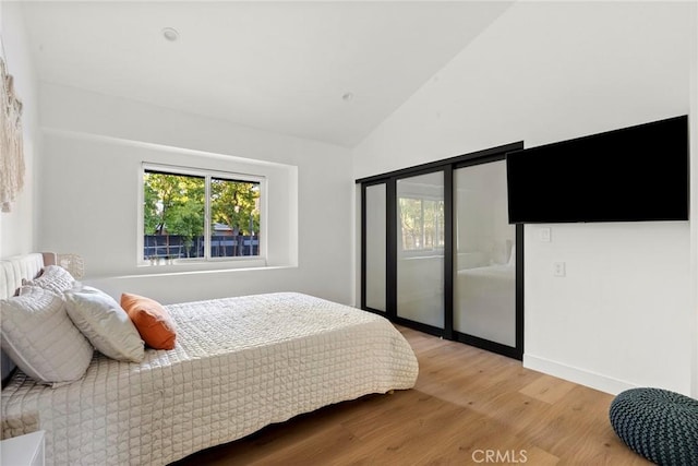 bedroom featuring vaulted ceiling and light hardwood / wood-style floors