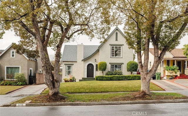 tudor house featuring a front lawn