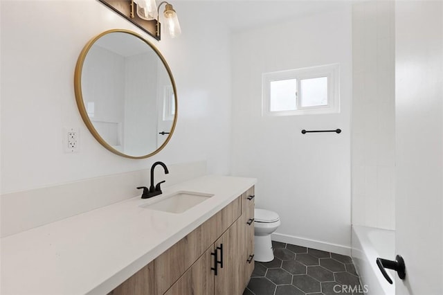 bathroom featuring vanity, tile patterned floors, and toilet