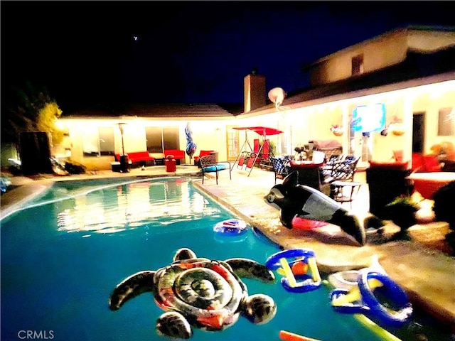 view of pool at night