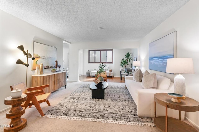 living room with light colored carpet and a textured ceiling