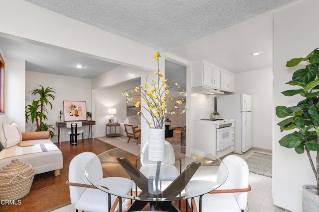 dining area with an inviting chandelier and a textured ceiling