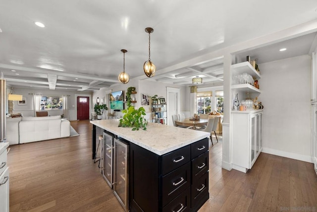 kitchen featuring a kitchen island, dark hardwood / wood-style flooring, a kitchen bar, hanging light fixtures, and coffered ceiling