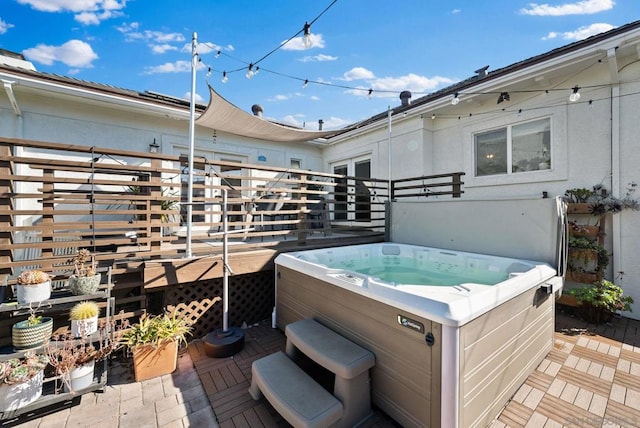 wooden deck with a hot tub