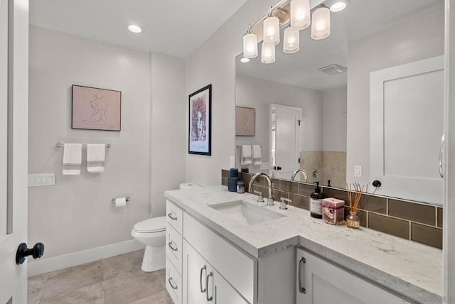 bathroom with vanity, tile patterned flooring, decorative backsplash, and toilet