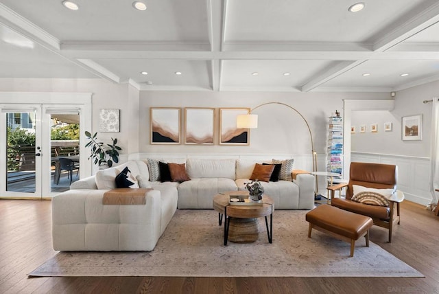 living room featuring coffered ceiling, light hardwood / wood-style flooring, ornamental molding, and beamed ceiling