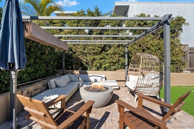 view of patio / terrace with an outdoor fire pit and a pergola