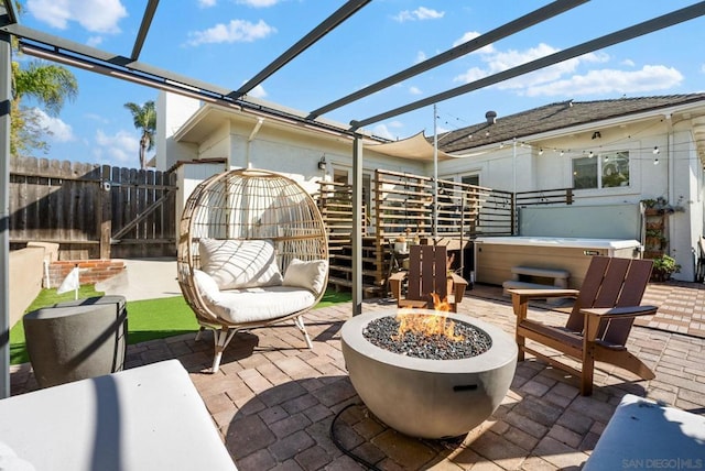 view of patio featuring a pergola, a fire pit, and a hot tub