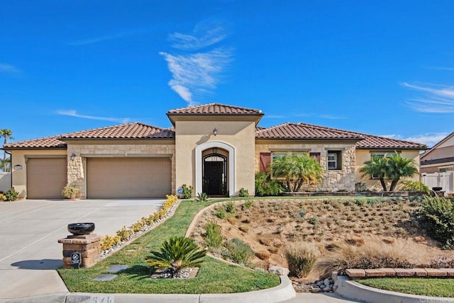 mediterranean / spanish home with a garage