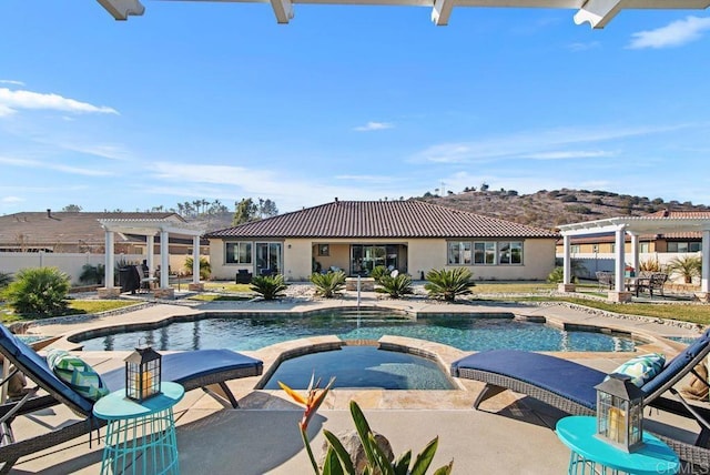 view of pool with an in ground hot tub, a pergola, and a patio