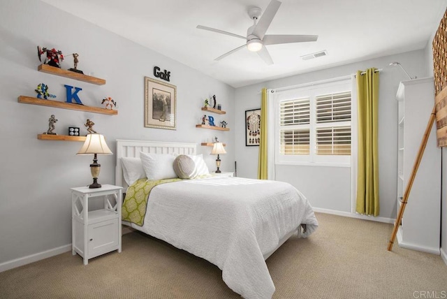 bedroom with ceiling fan and light carpet