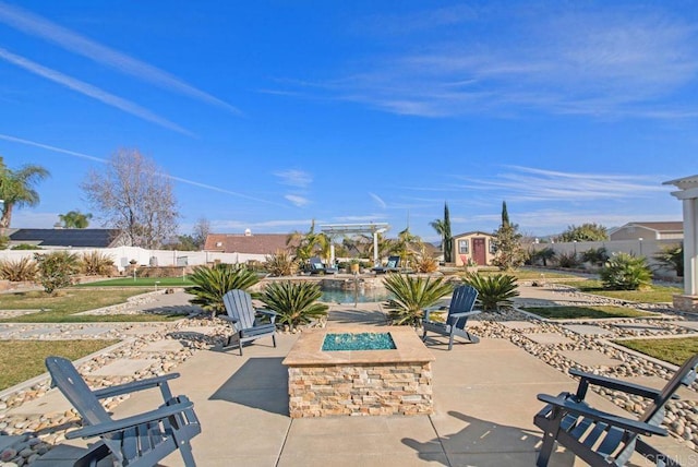 view of patio featuring a storage shed and a fire pit