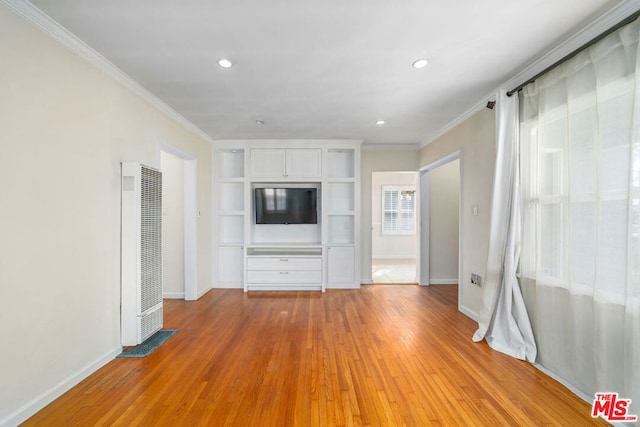 unfurnished living room with ornamental molding and light hardwood / wood-style floors