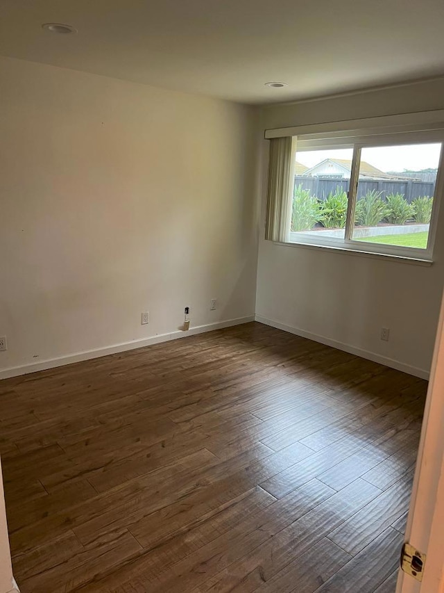 spare room with dark wood-type flooring