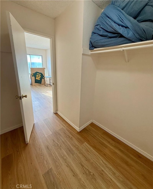 25925 Baylor Way, Hemet, CA 92544 - hall with baseboards, light wood finished floors, and a textured ceiling