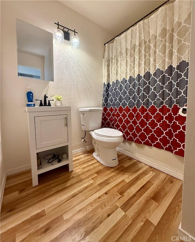 25925 Baylor Way, Hemet, CA 92544 - full bathroom with toilet, a shower with curtain, vanity, and wood finished floors