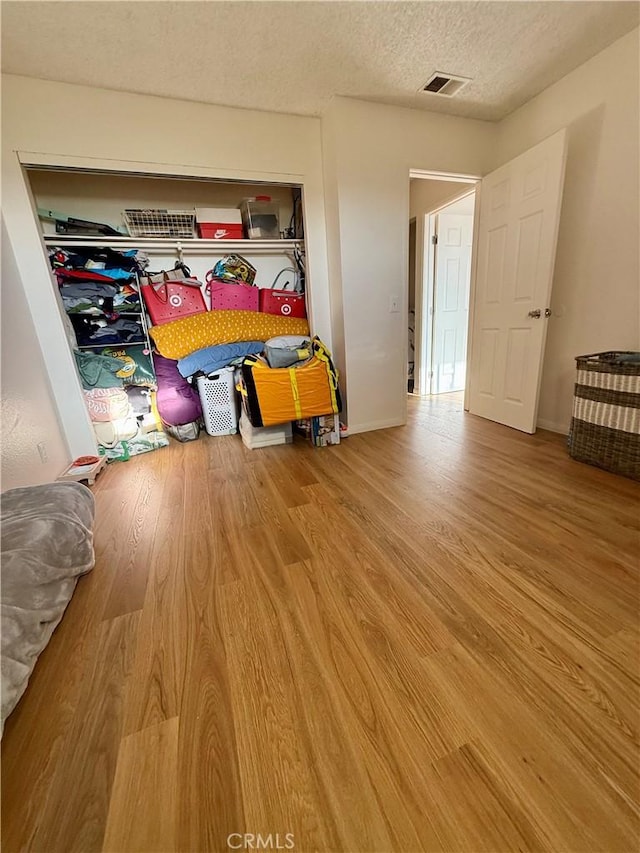 25925 Baylor Way, Hemet, CA 92544 - bedroom with visible vents, wood finished floors, and a textured ceiling