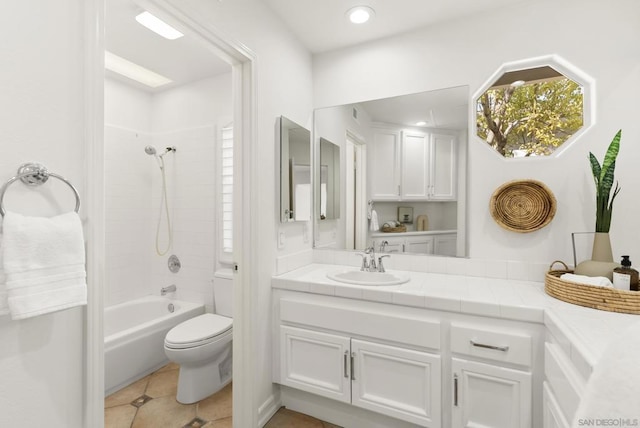 full bathroom with vanity, tile patterned floors, toilet, and washtub / shower combination