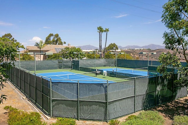 view of tennis court with a mountain view