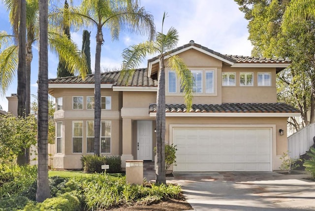 mediterranean / spanish-style house with a garage