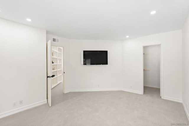 unfurnished room with light colored carpet