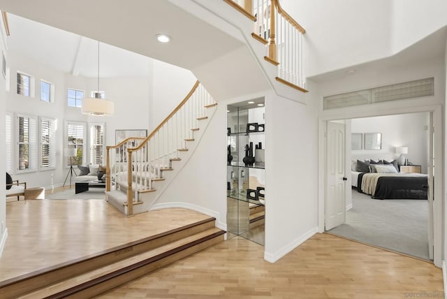 stairway featuring hardwood / wood-style floors and a high ceiling