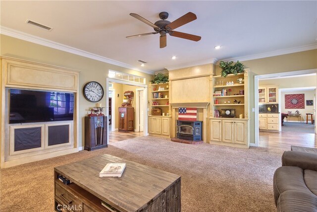 carpeted living room with ceiling fan and ornamental molding