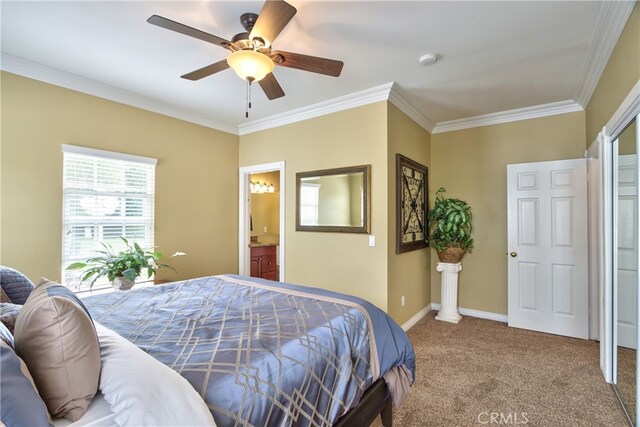 carpeted bedroom featuring connected bathroom, ornamental molding, and ceiling fan