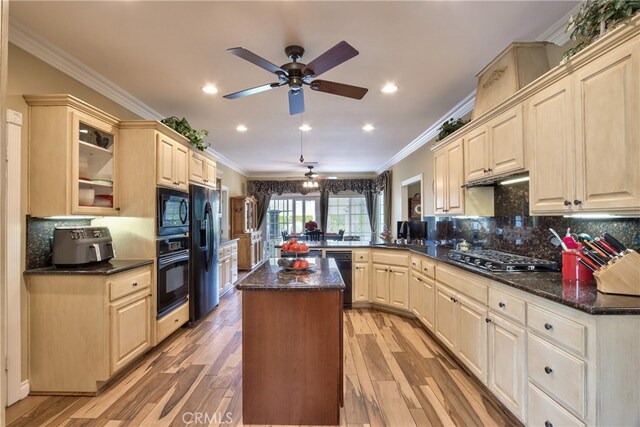 kitchen with tasteful backsplash, crown molding, kitchen peninsula, and black appliances