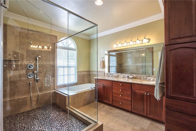 bathroom featuring crown molding, vanity, and independent shower and bath